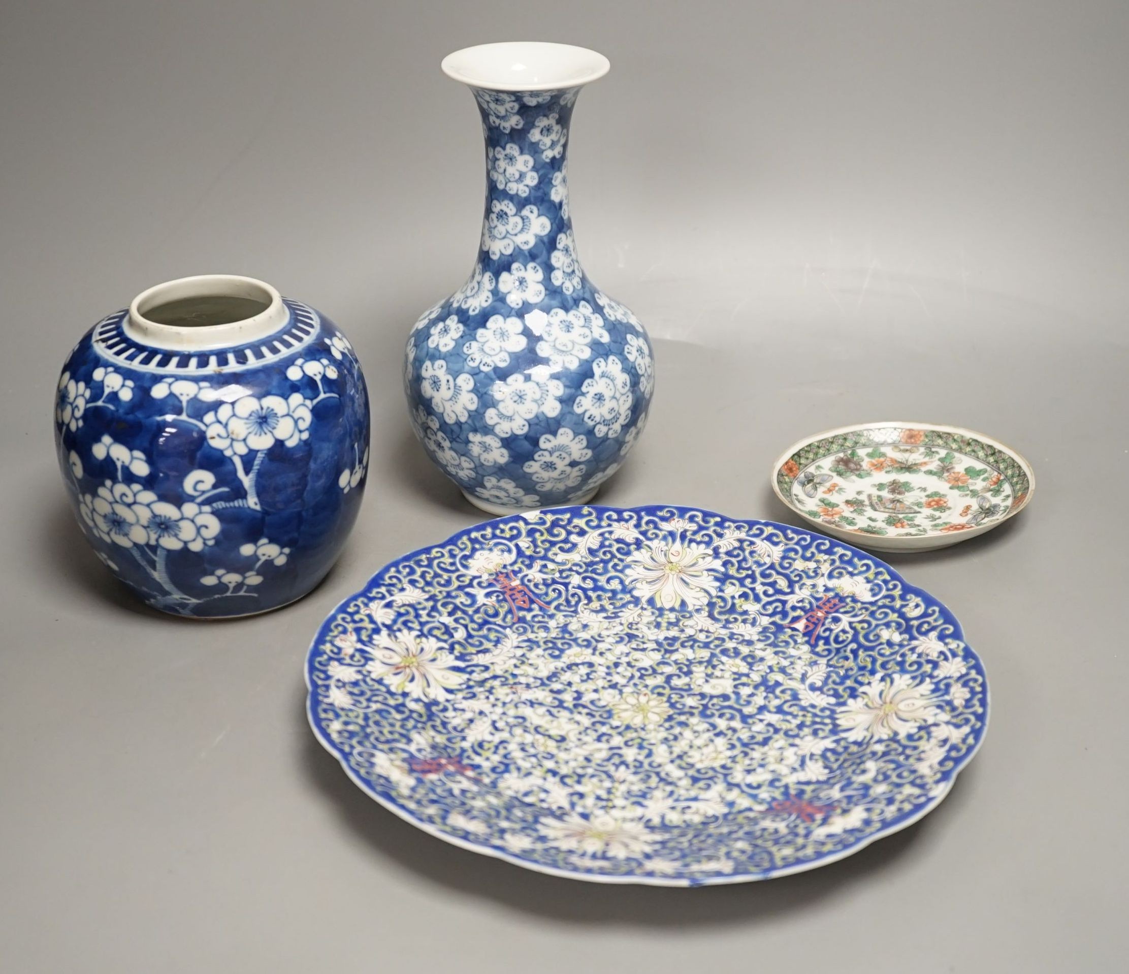 A Chinese blue and white jar, a similar vase, a polychrome plate and a famille verte saucer- plate 25 cms diameter.